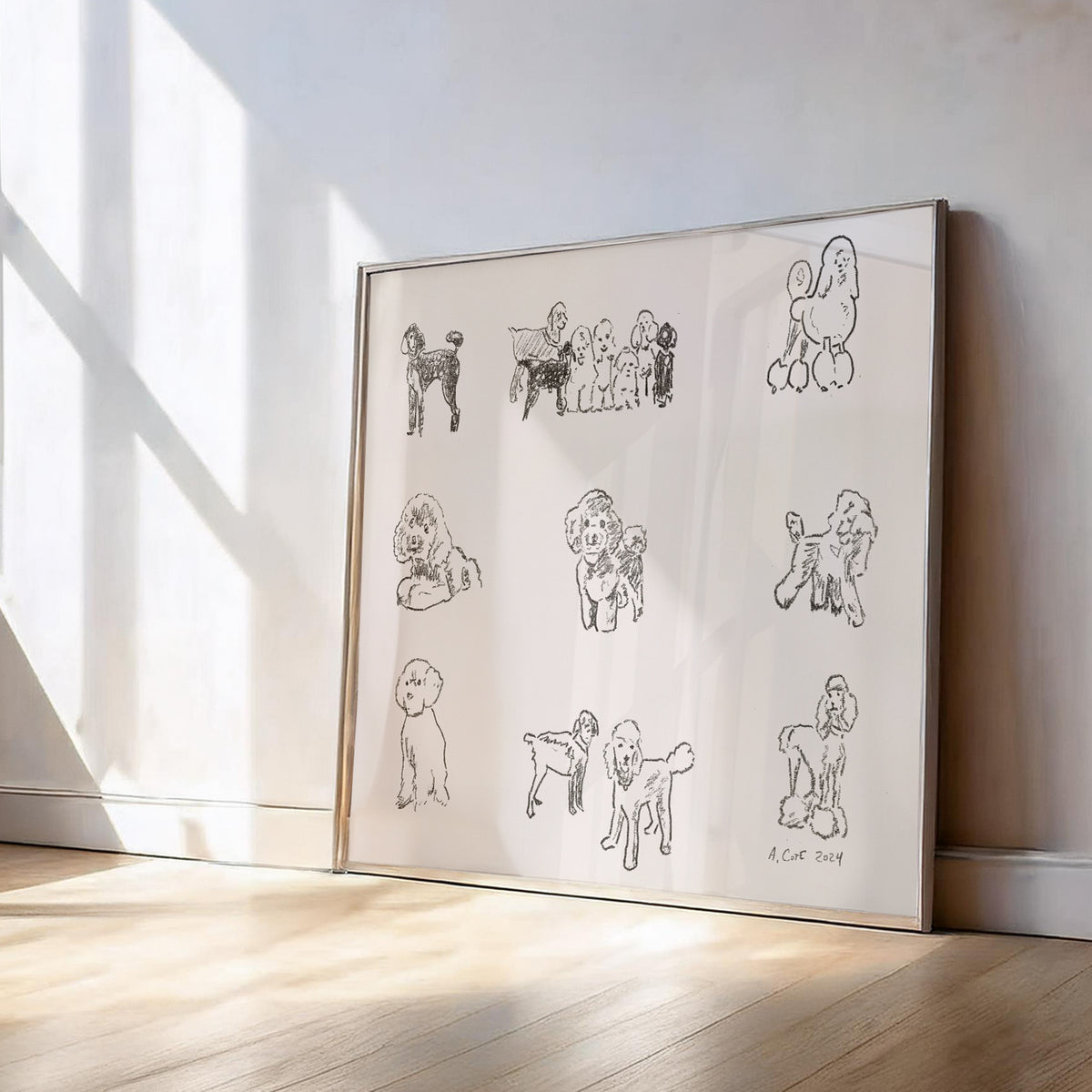 Framed artwork with line drawings of a dog on a white wall.