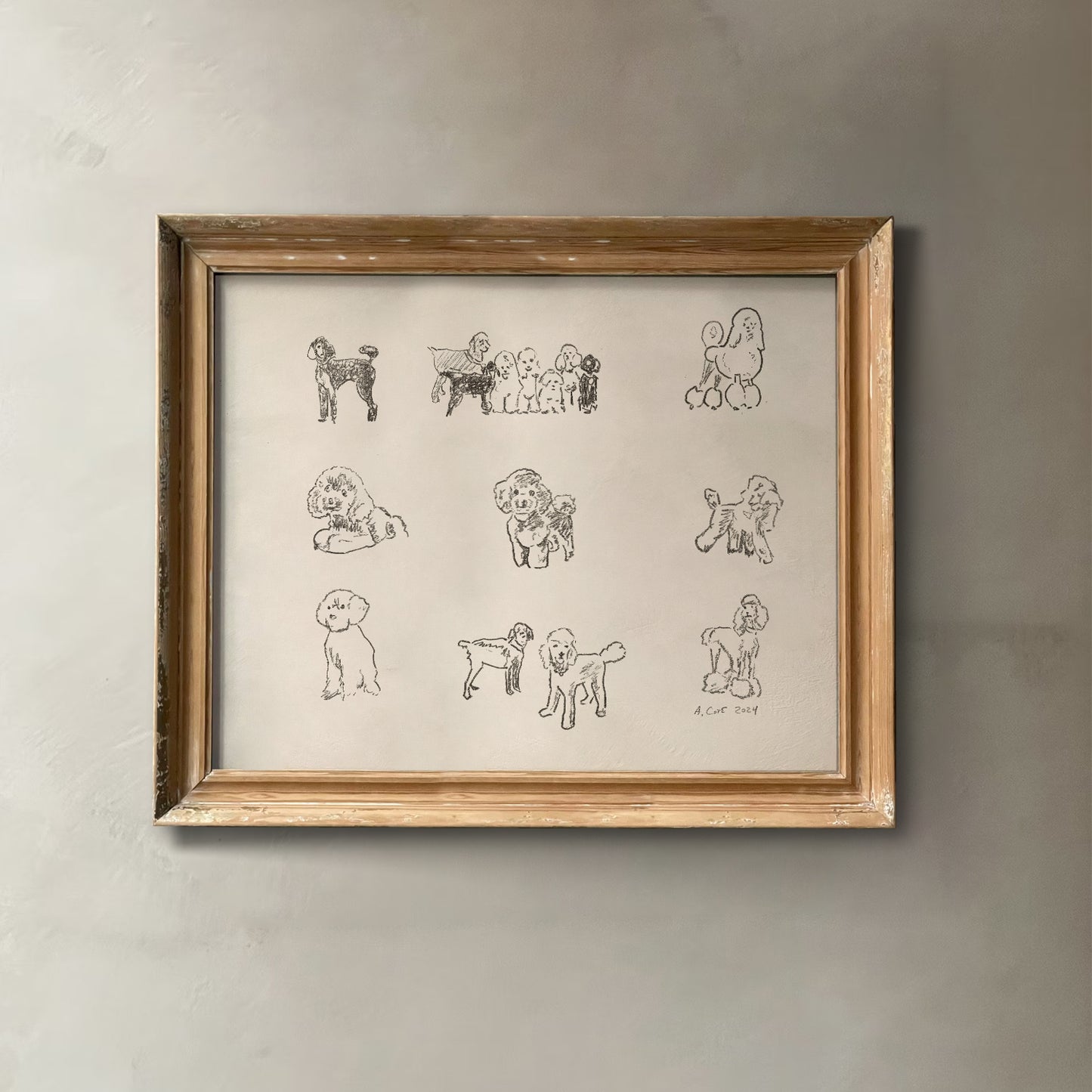 Framed artwork of black line drawings of dogs on a beige background