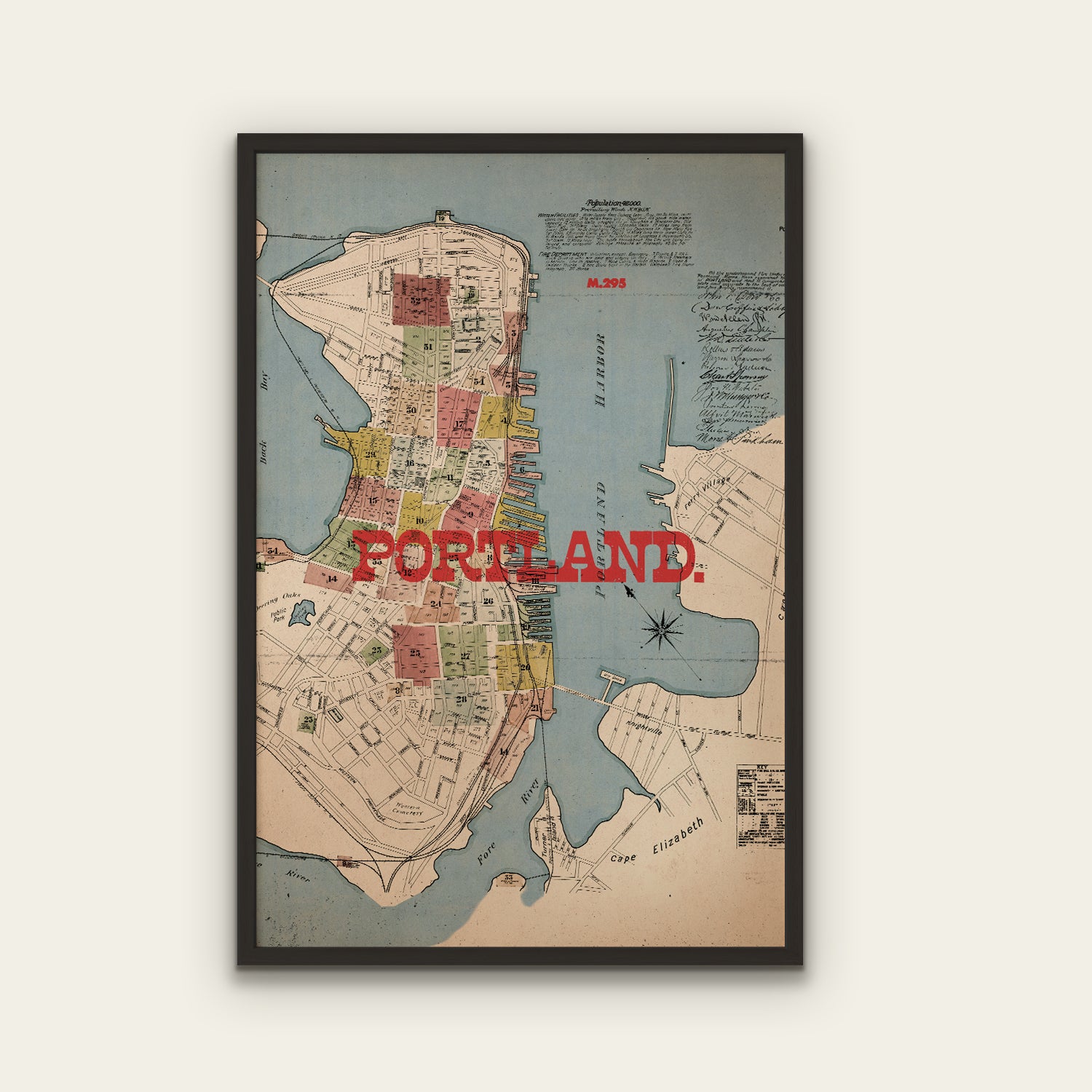 Framed map of Portland with 'Portland' text in red on a white background