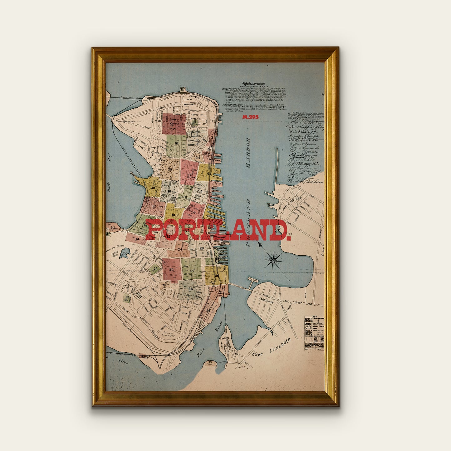 Framed map of Portland with a gold frame on a white wall