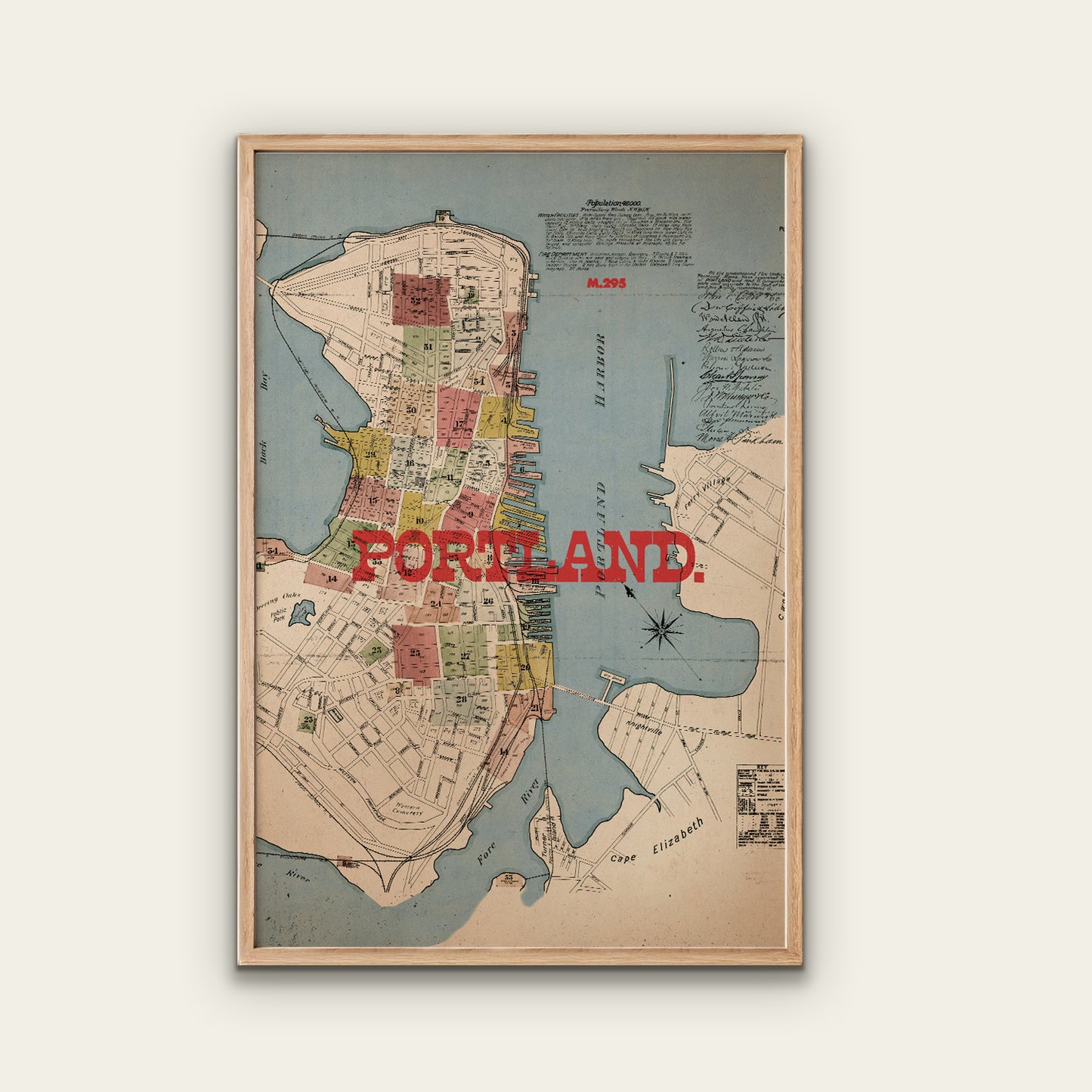 Framed map of Portland with a wooden frame on a white wall