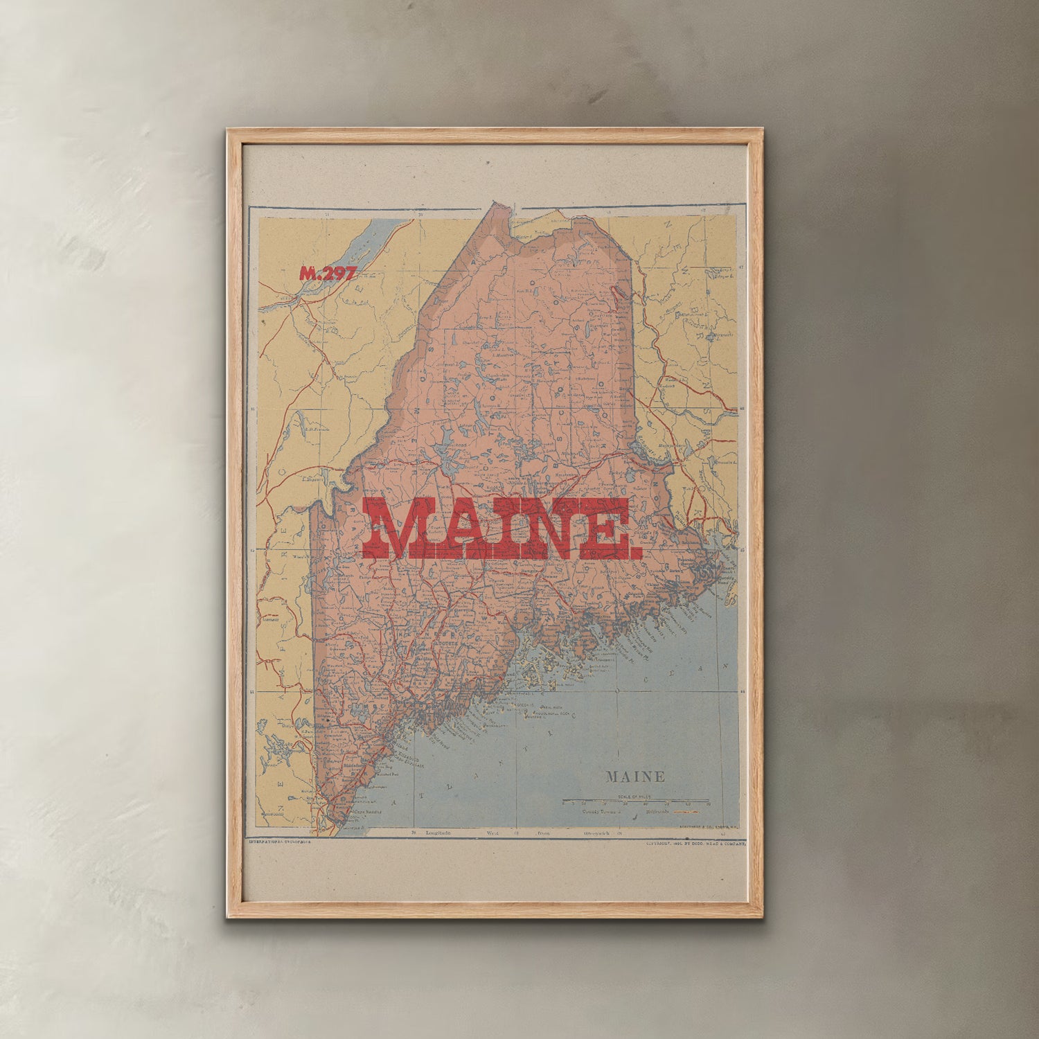 Framed map of Maine on a textured wall