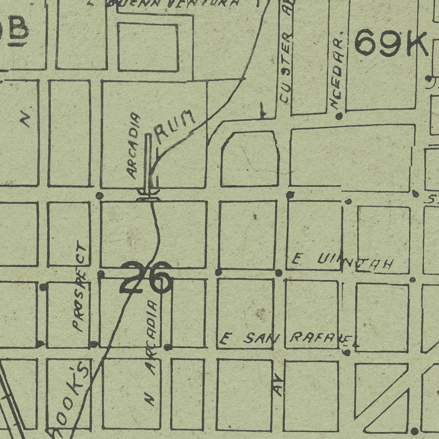 A close-up of a vintage street map print showing labeled blocks, handwritten street names, and the number 26 in large ink numerals.