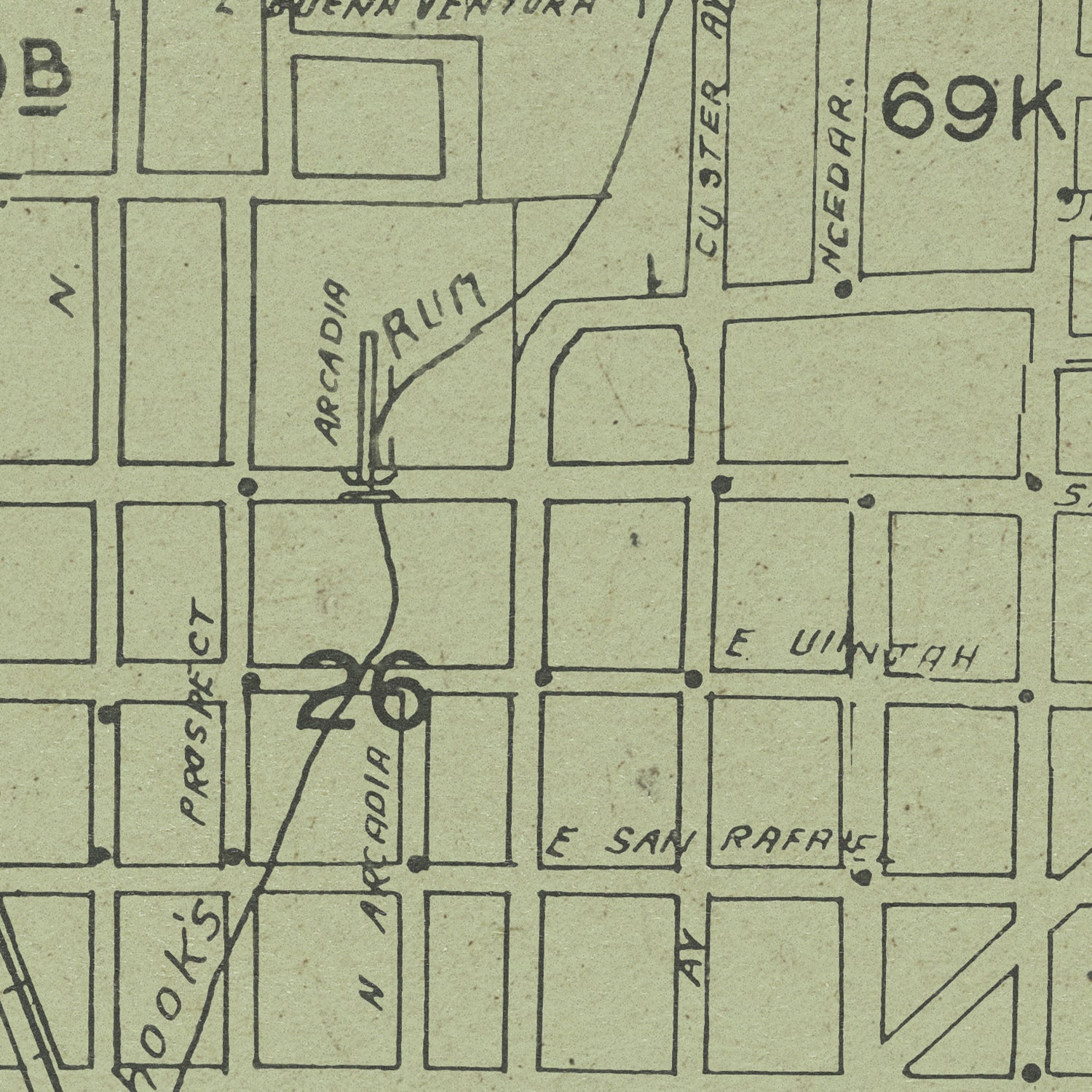 A close-up of a vintage street map print showing labeled blocks, handwritten street names, and the number 26 in large ink numerals.