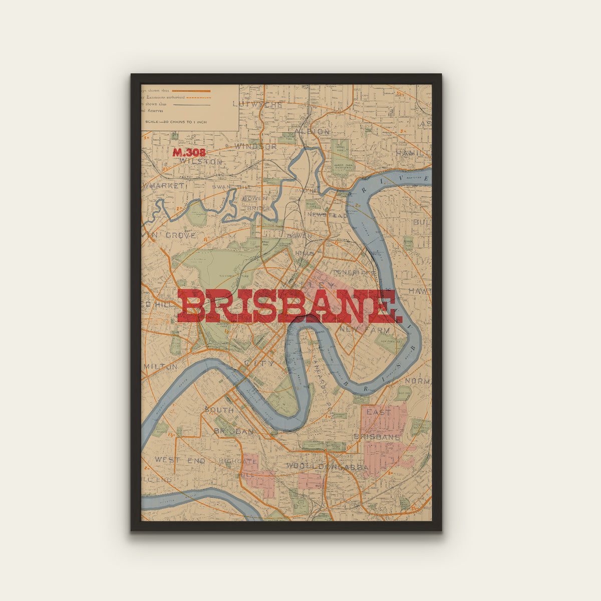 A framed vintage-style map print of Brisbane, Australia, featuring a beige background, blue river, orange road lines, and large red 'BRISBANE' text across the center, shown against a light warm gray wall.