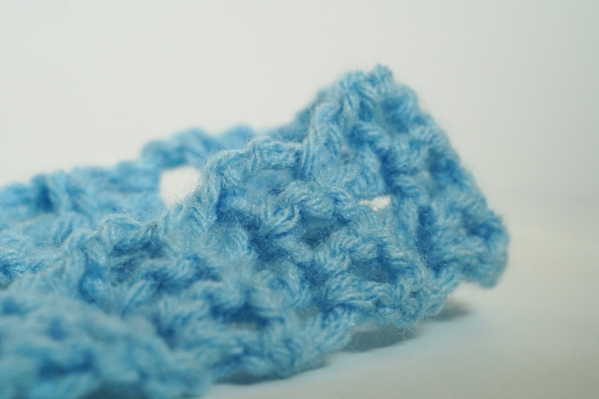Blue knitted headband on a white background