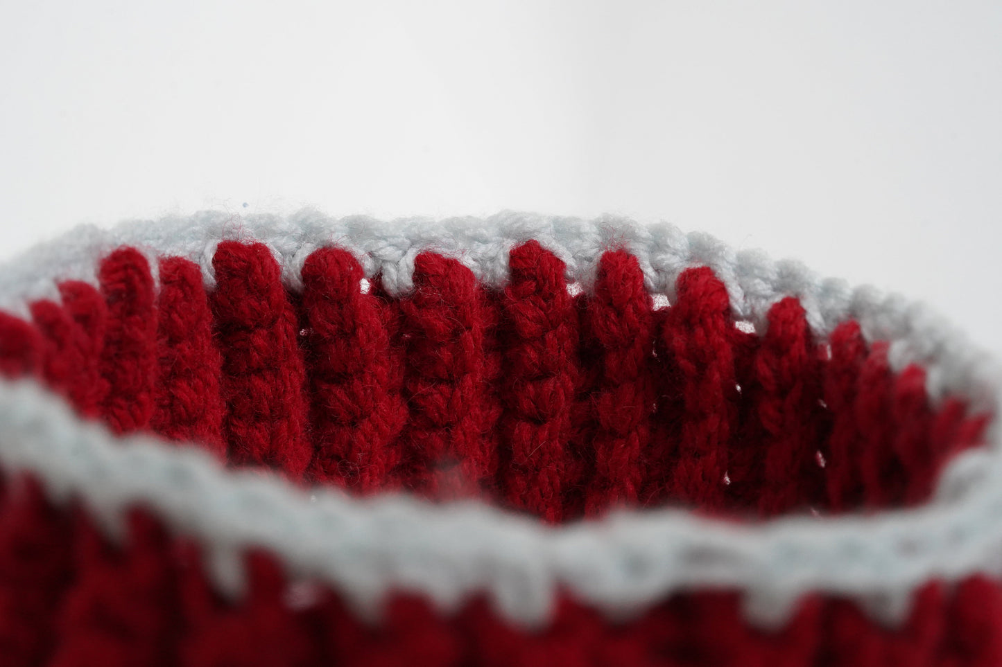 Close-up of a red and white crocheted headband