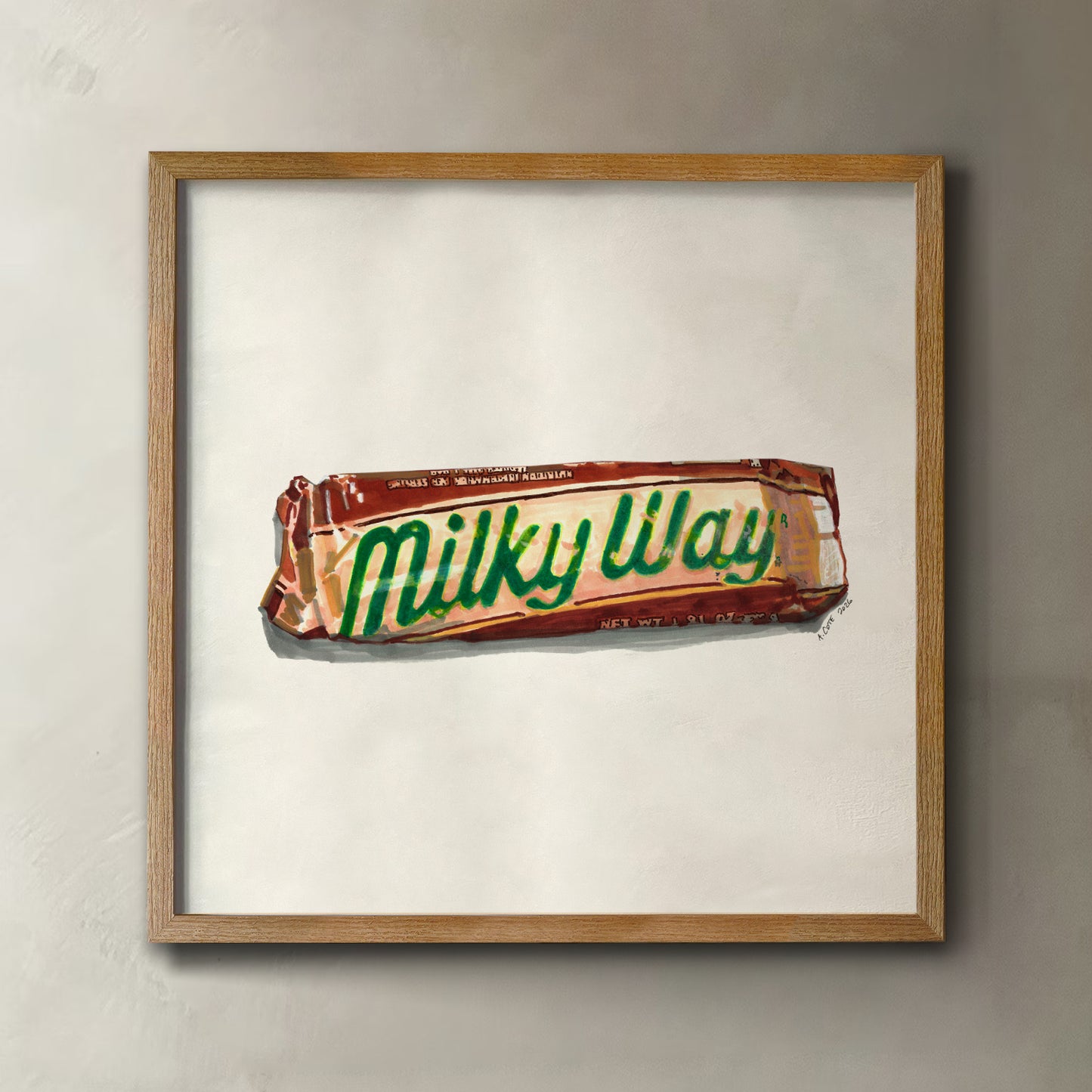 A framed art print featuring a painted illustration of a Milky Way candy bar on an off-white background, enclosed in a light wood frame and mounted on a textured gray wall.