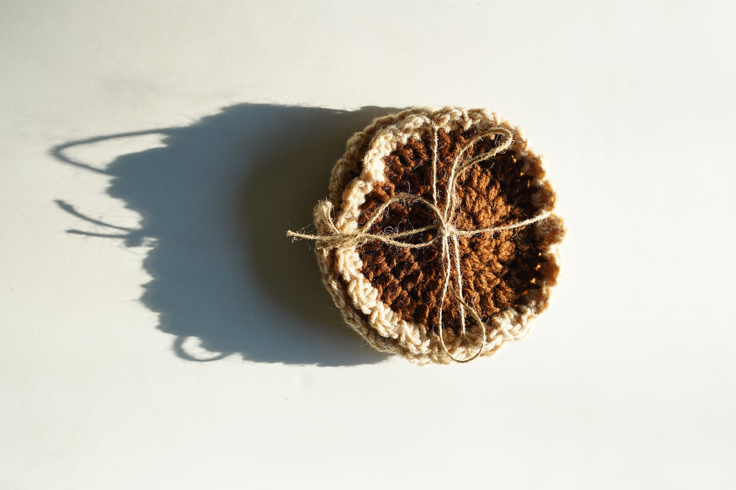 Crocheted brown coasters on a white background