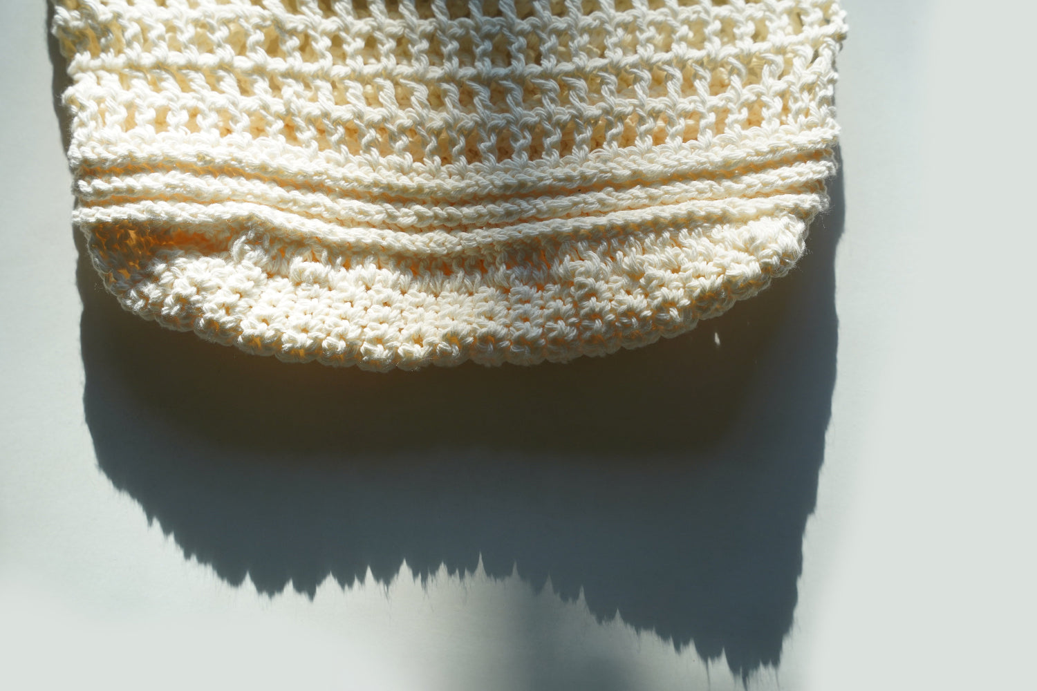 Cream crocheted bag on a light gray background