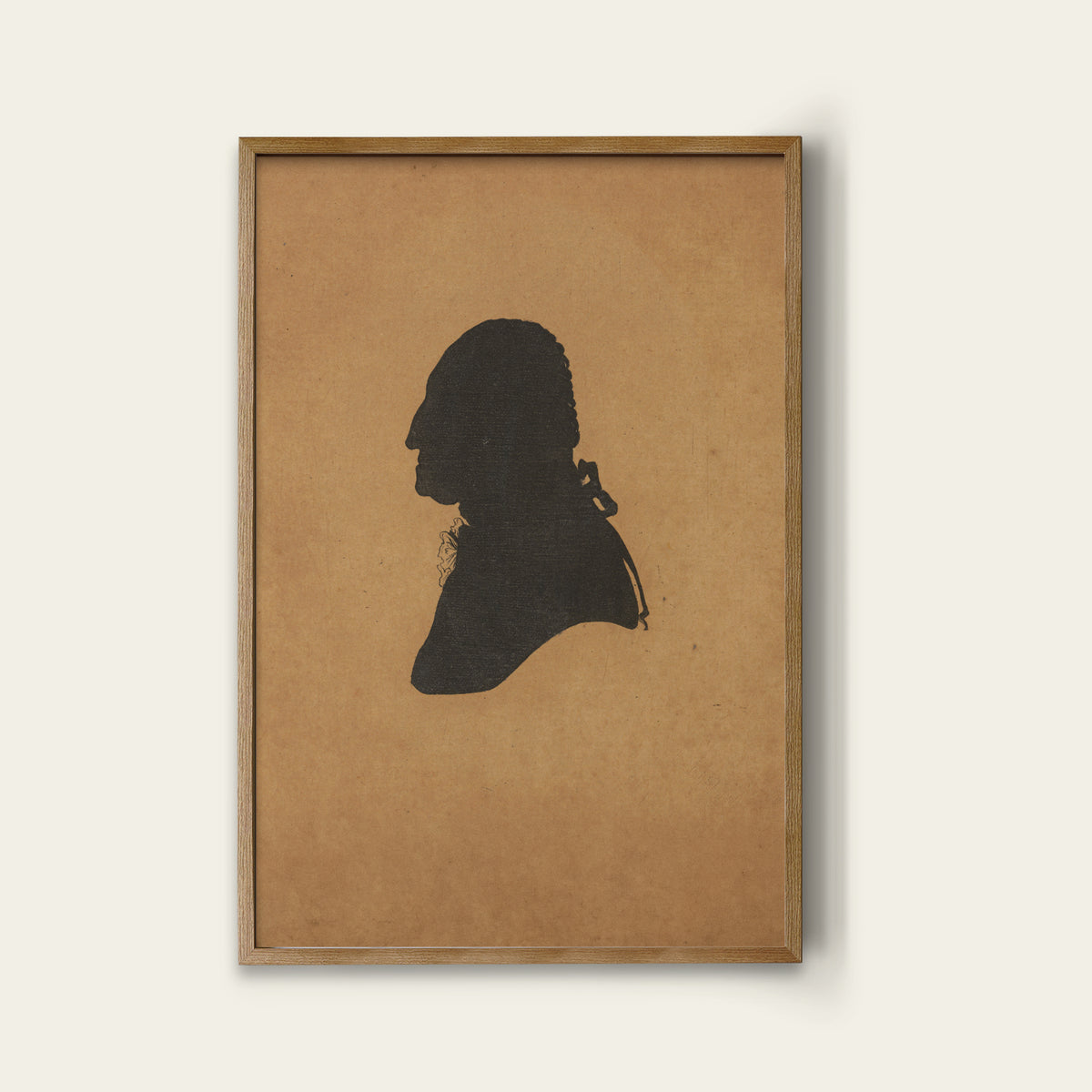 Framed silhouette of George Washington on brown paper against a white background